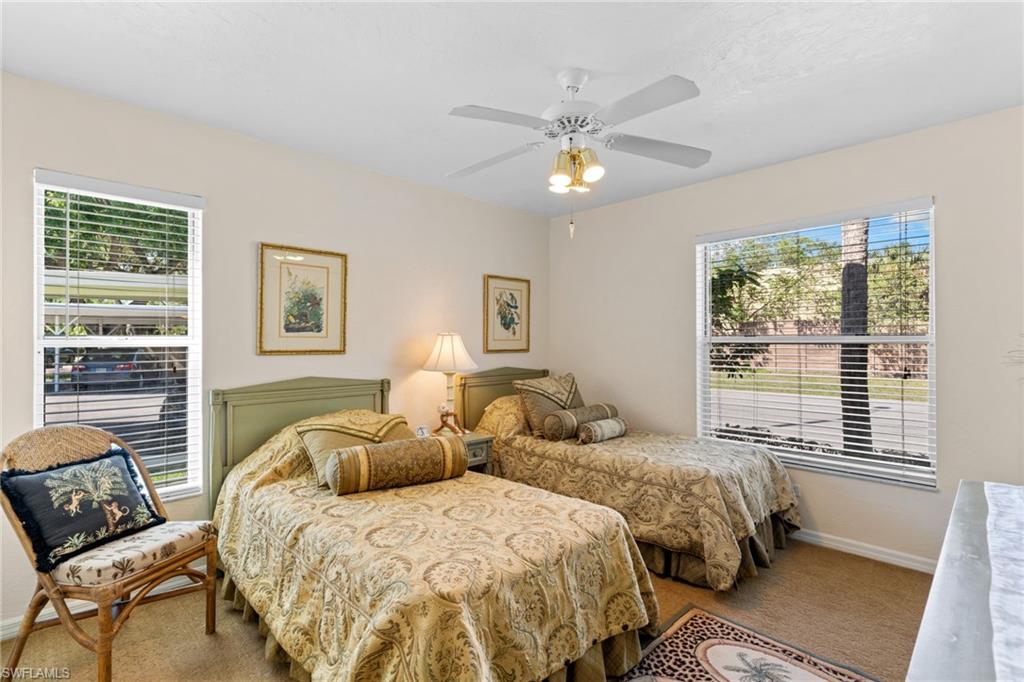 776 Landover Circle, Unit 104 Naples, FL 34104 - Photo 17 of 25 a bedroom with two beds and a window