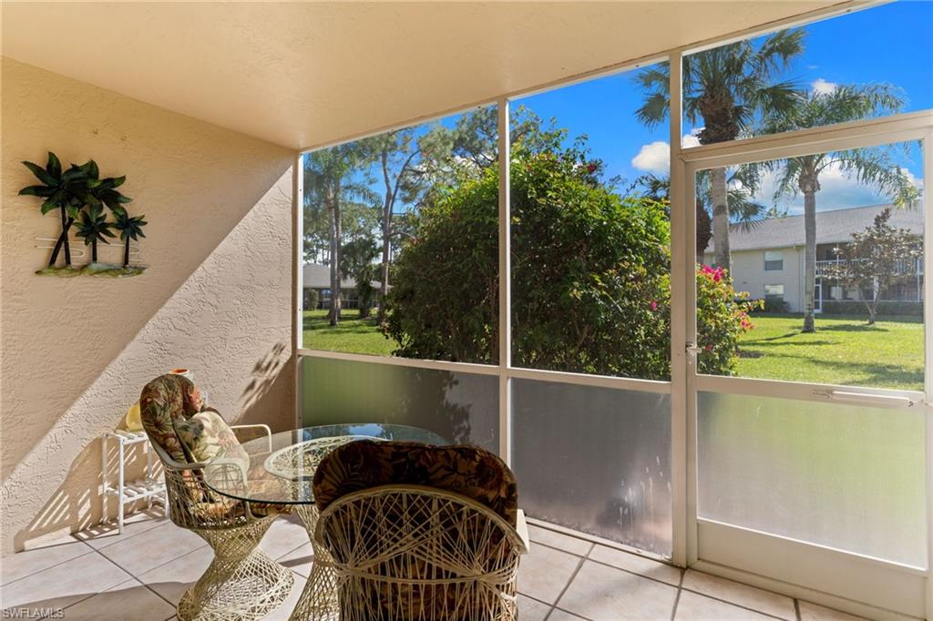 776 Landover Circle, Unit 104 Naples, FL 34104 - Photo 18 of 25 a front view of a house with garden