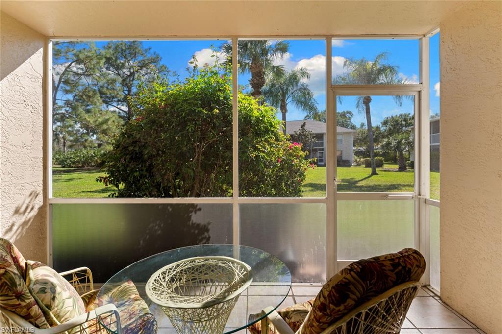 776 Landover Circle, Unit 104 Naples, FL 34104 - Photo 19 of 25 a balcony with table and chairs