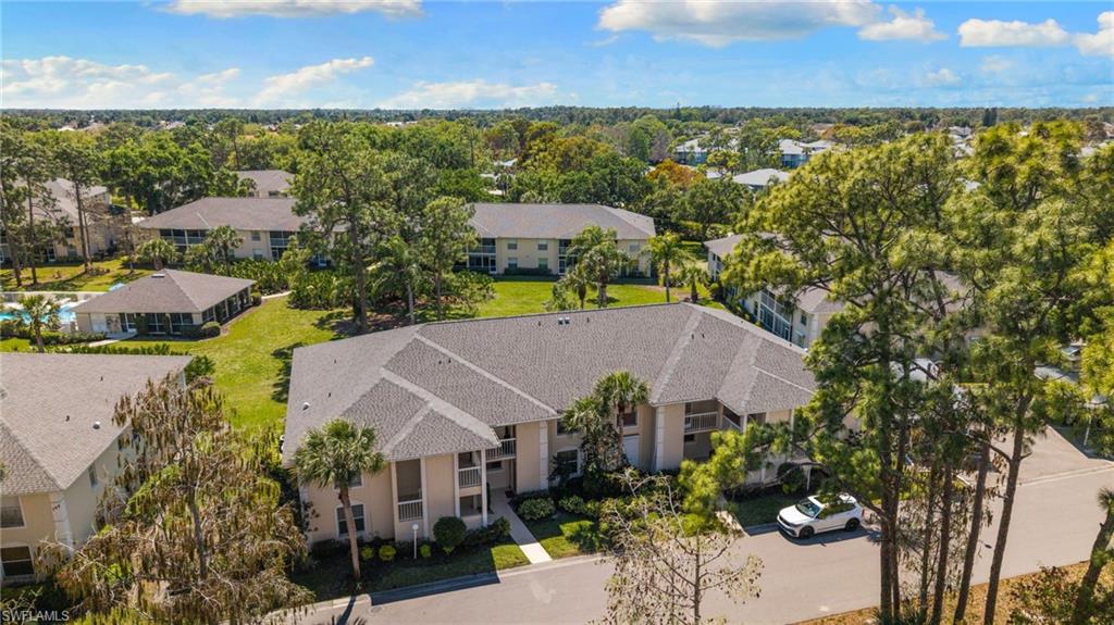 776 Landover Circle, Unit 104 Naples, FL 34104 - Photo 2 of 25 an aerial view of a house with a garden