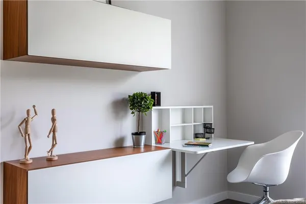 a view of a hallway with washer and dryer to living room