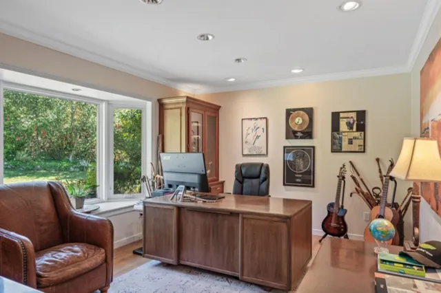 a living room with furniture a flat screen tv and a floor to ceiling window