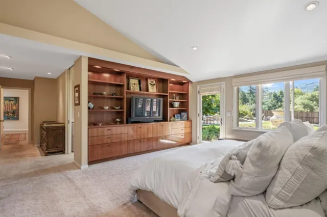 a bedroom with a large bed and a large window