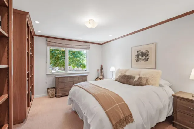 a bedroom with a large bed and a window