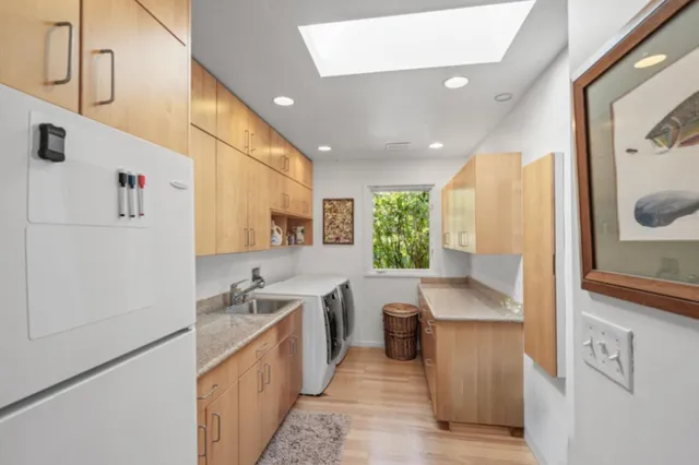 a kitchen with granite countertop a sink stove and refrigerator
