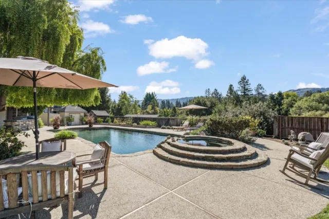 a view of a swimming pool and lounge chairs