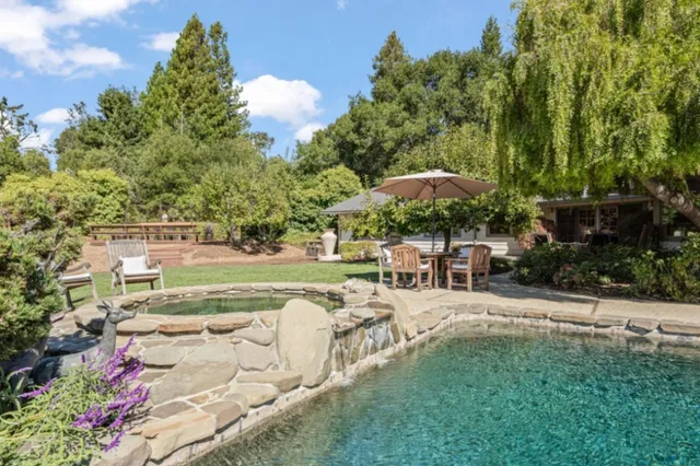 a view of a swimming pool with a patio