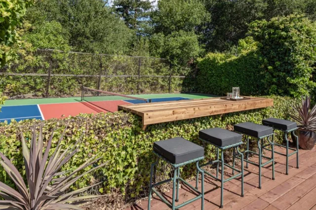 a view of an outdoor sitting area with brick walls