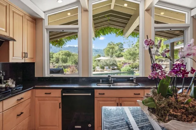 a kitchen with a sink and large window