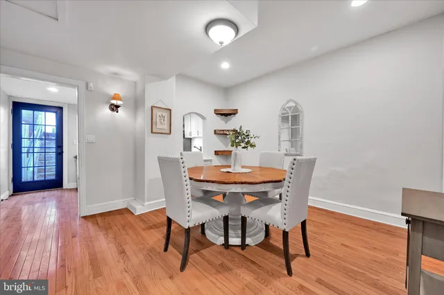 a dining room with furniture and wooden floor