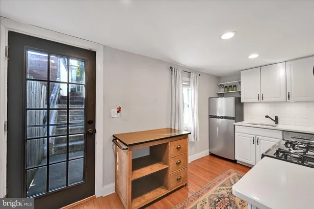 a kitchen with stainless steel appliances a stove a microwave and a refrigerator