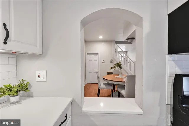 an empty room with windows and closet area