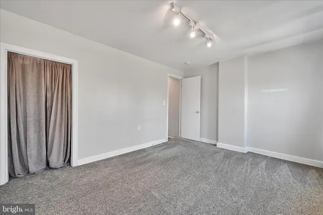 a view of an empty room with a fireplace