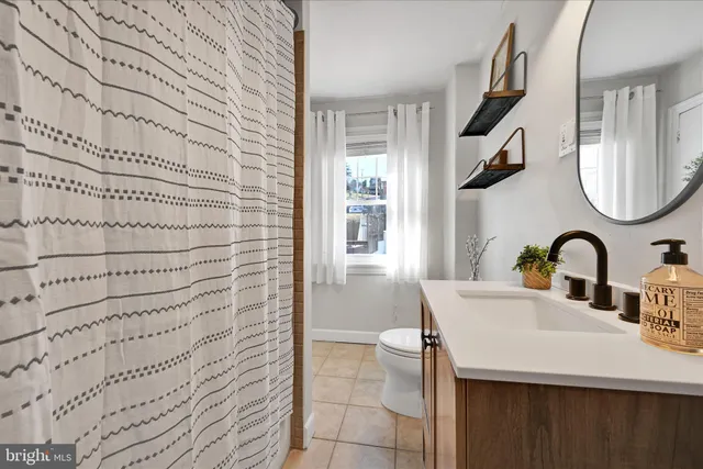 a bathroom with a sink a mirror and a shower