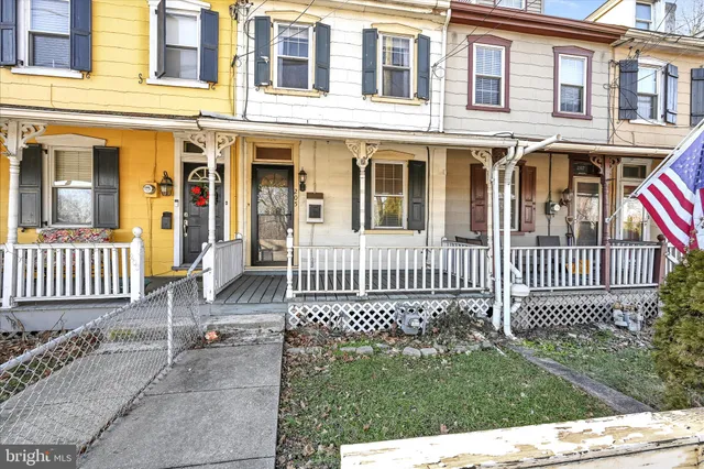 a furnished livingroom with windows and wooden floor