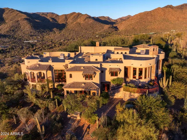 a kitchen with stainless steel appliances granite countertop a kitchen island and chairs in it