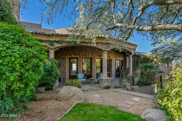 a view of a patio with couches table and chairs and potted plants