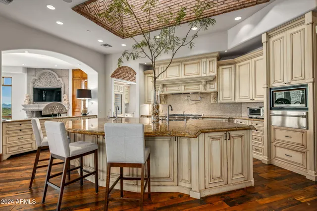 a living room with furniture fireplace and a large window