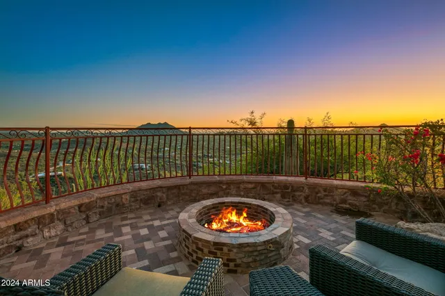 a living room with furniture fireplace and a large window