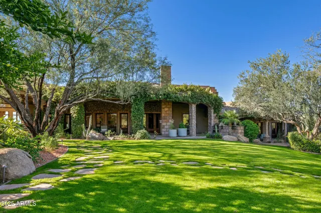 a view of a backyard with plants and patio