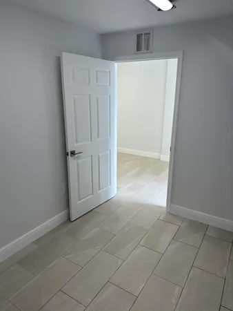 an empty room with cabinet door