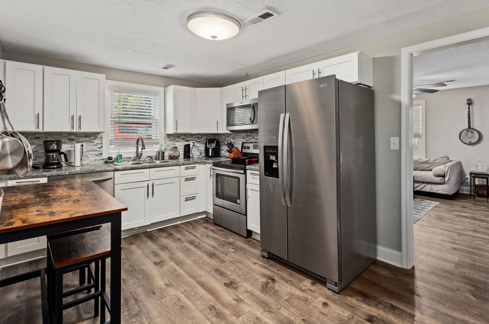2531 Pleasant View Road Pleasant View, TN 37146 - Photo 11 of 35 a kitchen with stainless steel appliances a refrigerator a sink a stove a table and chairs