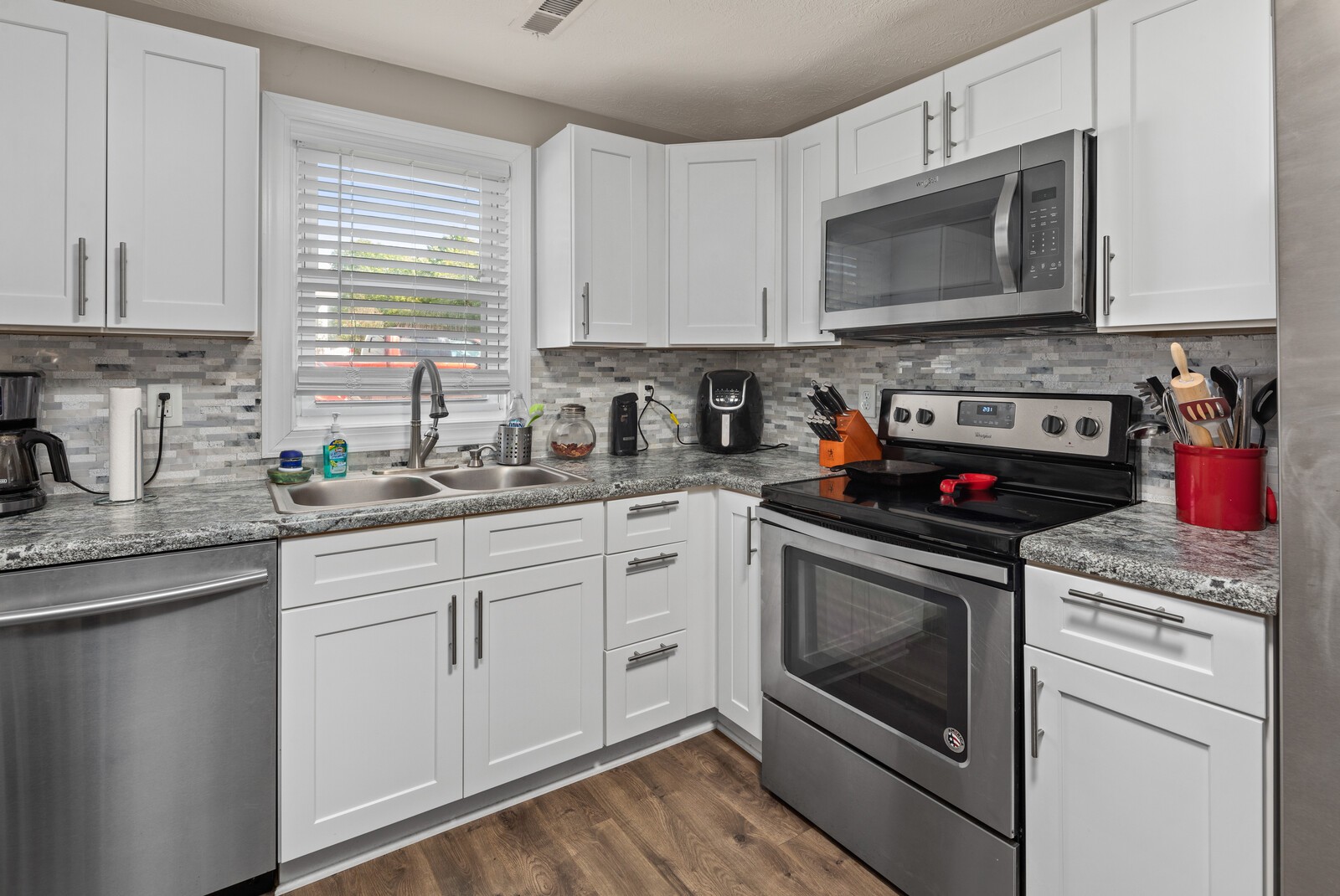 2531 Pleasant View Road Pleasant View, TN 37146 - Photo 12 of 35 a kitchen with stainless steel appliances granite countertop a stove a microwave and cabinets
