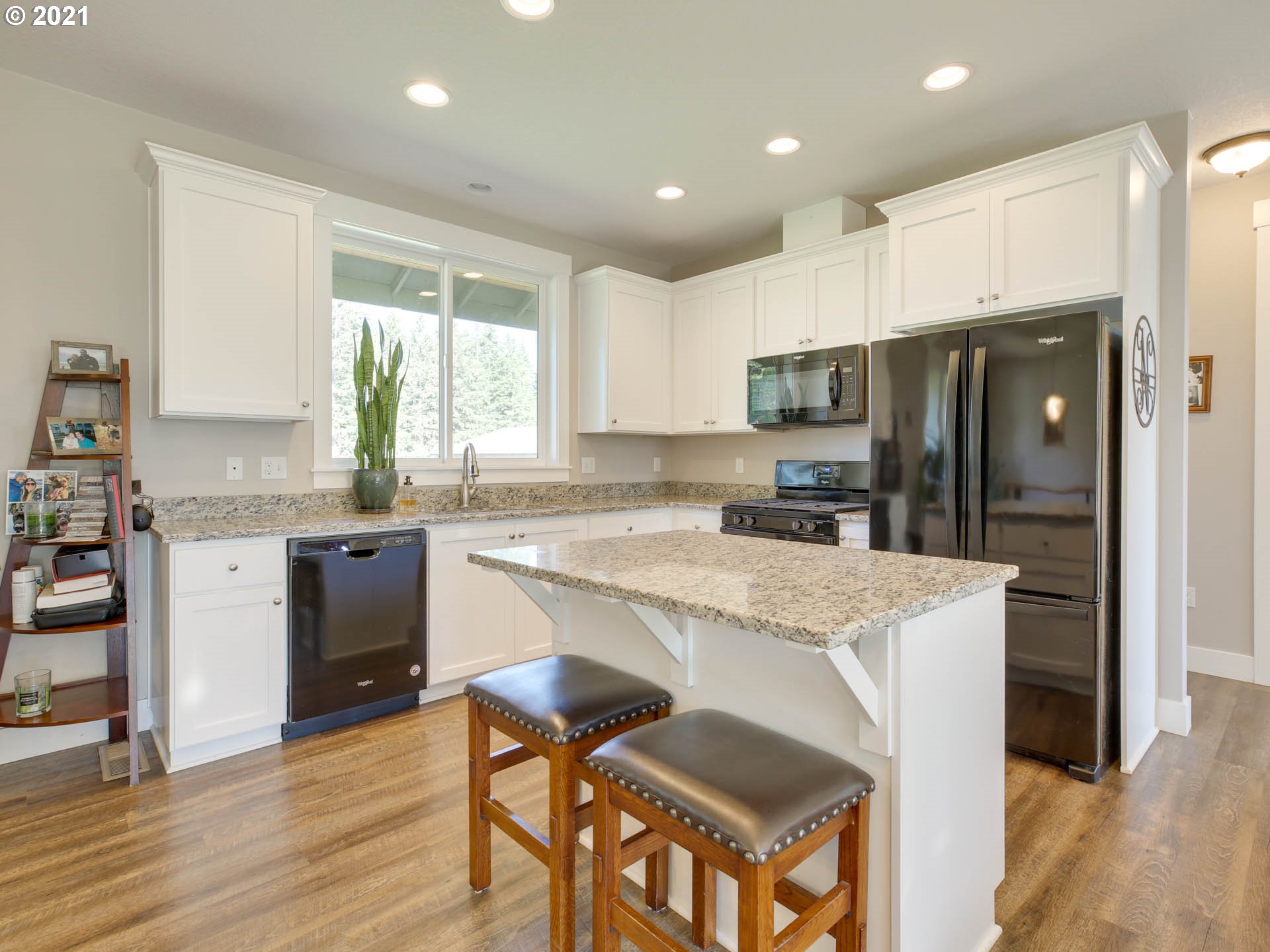 20071 South Ridge Road Oregon City, OR 97045 - Photo 8 of 32 a kitchen with kitchen island granite countertop wooden cabinets and a refrigerator