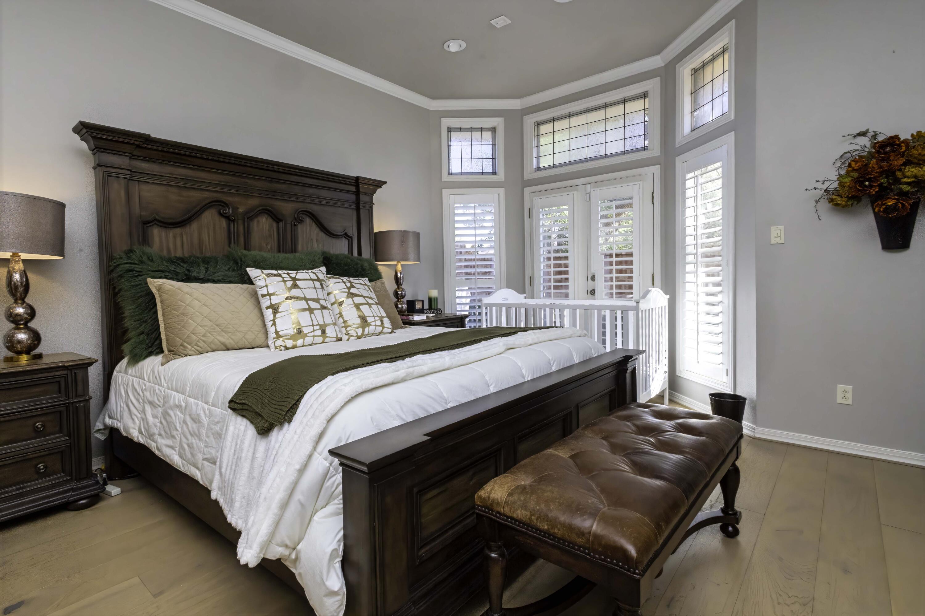 5101 2nd Street Lubbock, TX 79416 - Photo 19 of 41 a bedroom with a bed and a dresser next to a window