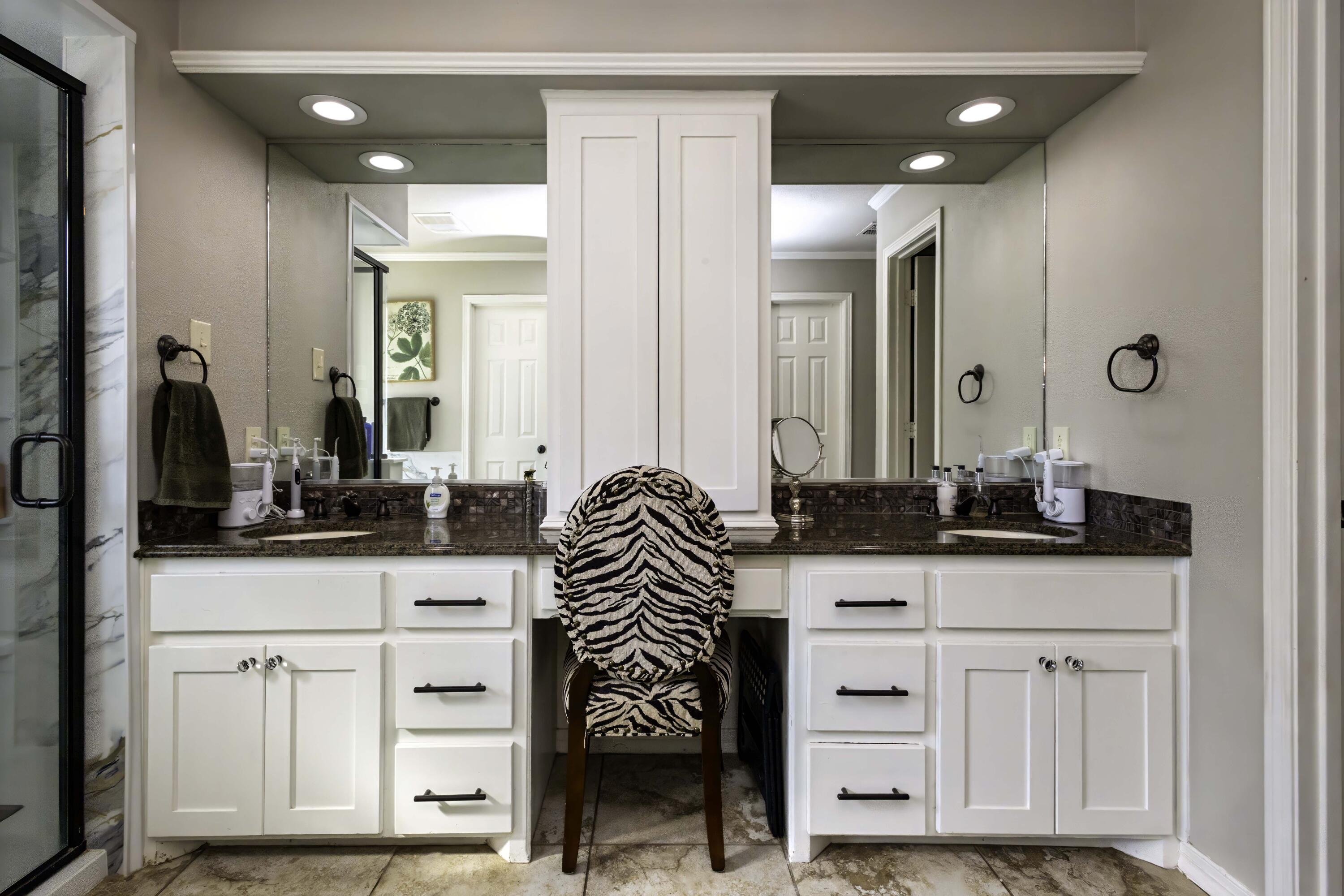5101 2nd Street Lubbock, TX 79416 - Photo 22 of 41 a bathroom with a sink vanity and a mirror