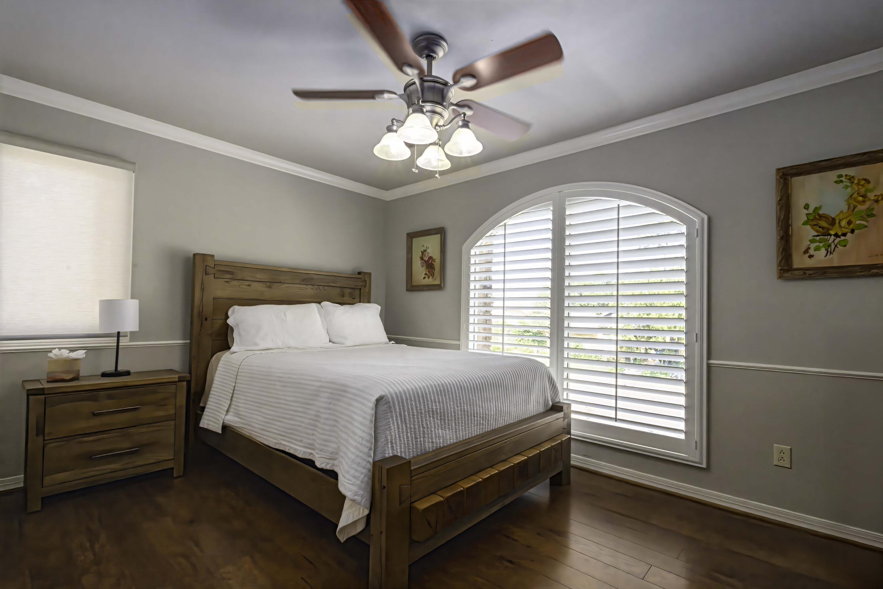 5101 2nd Street Lubbock, TX 79416 - Photo 24 of 41 a bedroom with a bed and a chandelier