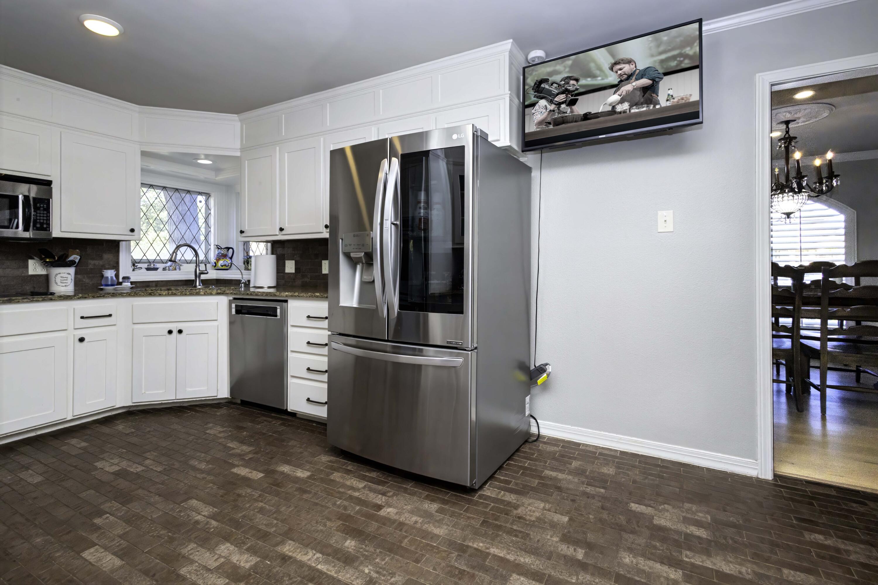 5101 2nd Street Lubbock, TX 79416 - Photo 8 of 41 a kitchen with stainless steel appliances a refrigerator sink and cabinets