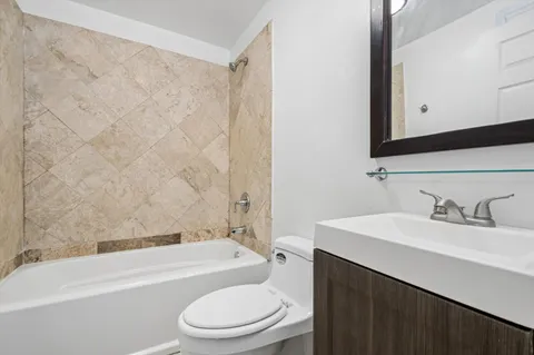 a bathroom with a sink a toilet and a bathtub