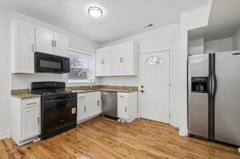 a kitchen with a refrigerator stove and microwave