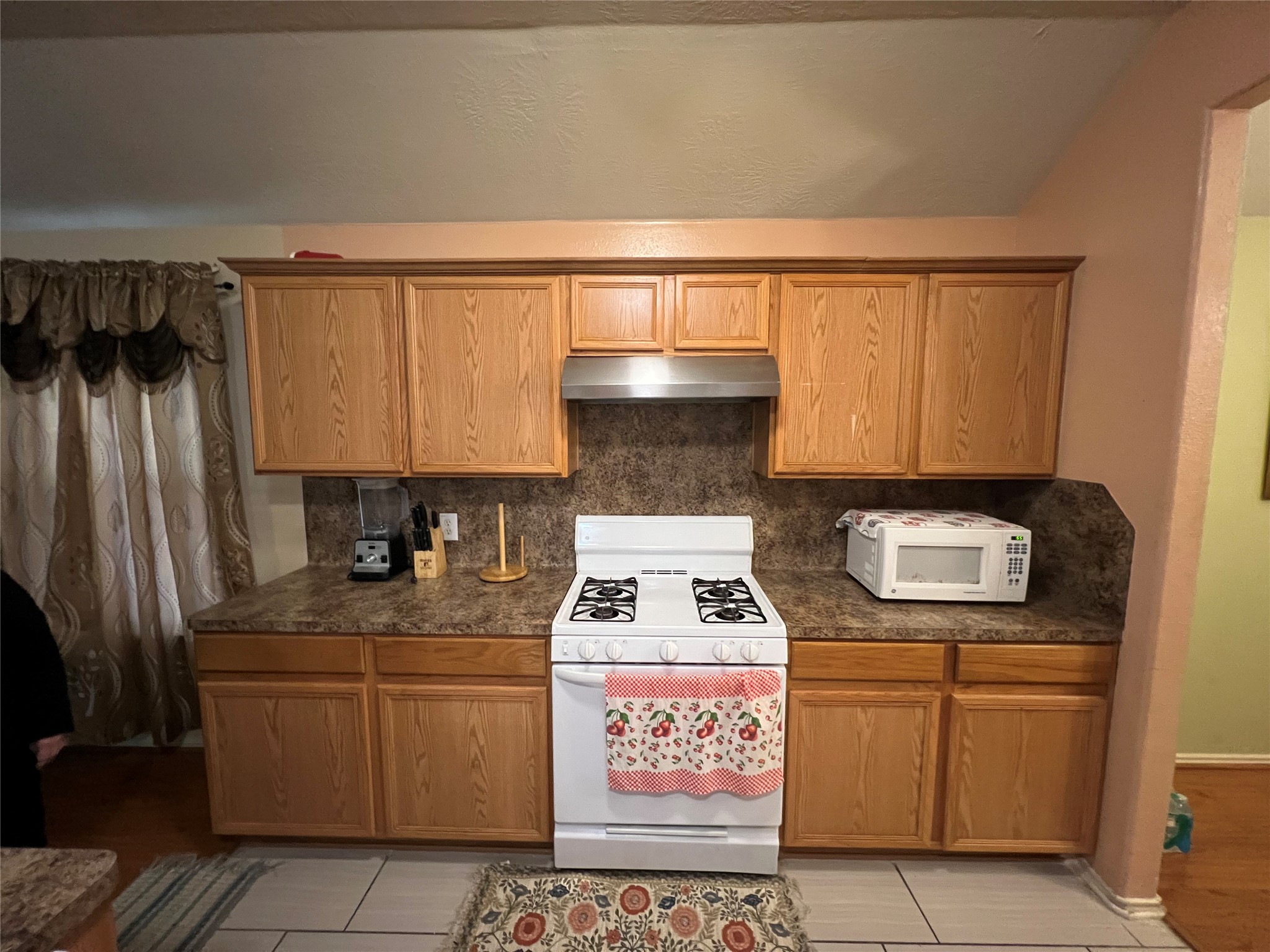 20002 Karlanda Lane Houston, TX 77073 - Photo 20 of 24 a kitchen with granite countertop a stove a sink and a refrigerator