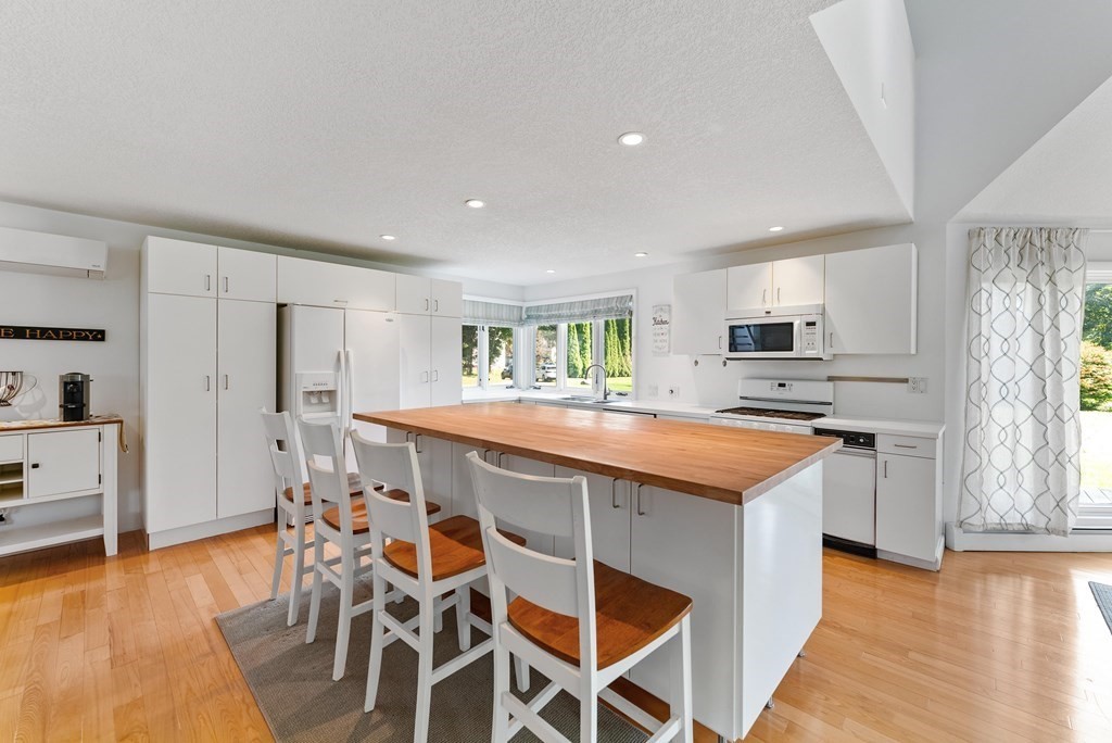 54 Kennedy Street Chicopee, MA 01013 - Photo 15 of 42 a kitchen with stainless steel appliances kitchen island granite countertop a table chairs sink and cabinets