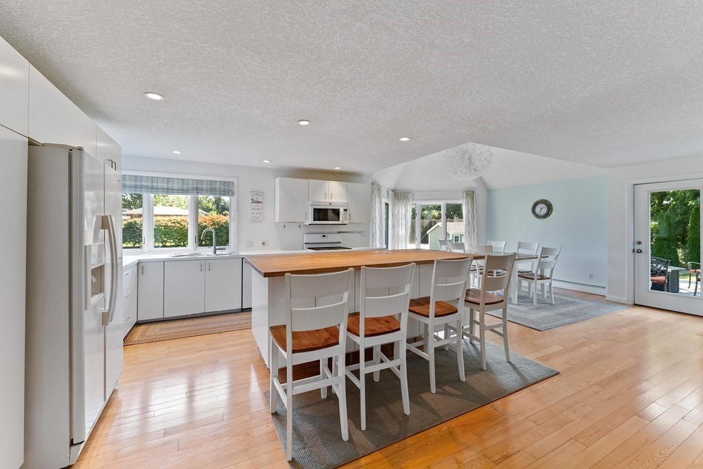 54 Kennedy Street Chicopee, MA 01013 - Photo 16 of 42 a dining hall with stainless steel appliances kitchen island granite countertop a dining table chairs and granite counter tops