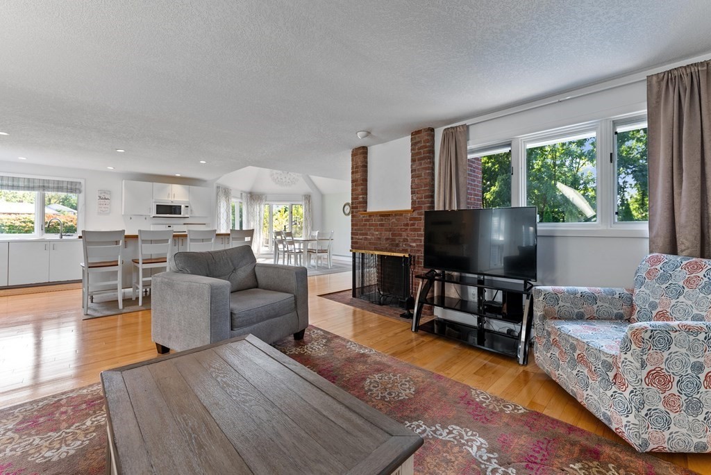 54 Kennedy Street Chicopee, MA 01013 - Photo 17 of 42 a living room with furniture a fireplace and a flat screen tv