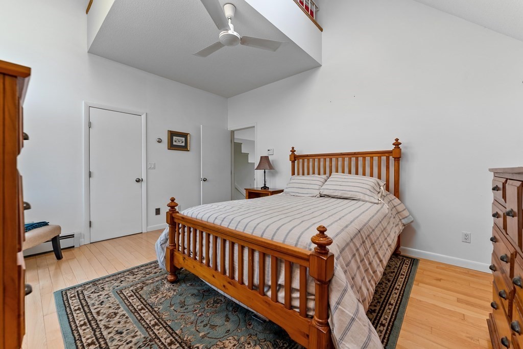 54 Kennedy Street Chicopee, MA 01013 - Photo 20 of 42 a bedroom with a bed and wooden floor