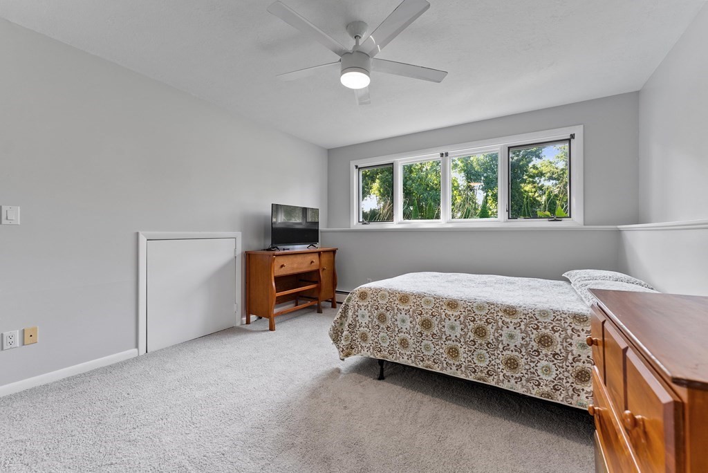 54 Kennedy Street Chicopee, MA 01013 - Photo 32 of 42 a bed room with a bed and a ceiling fan