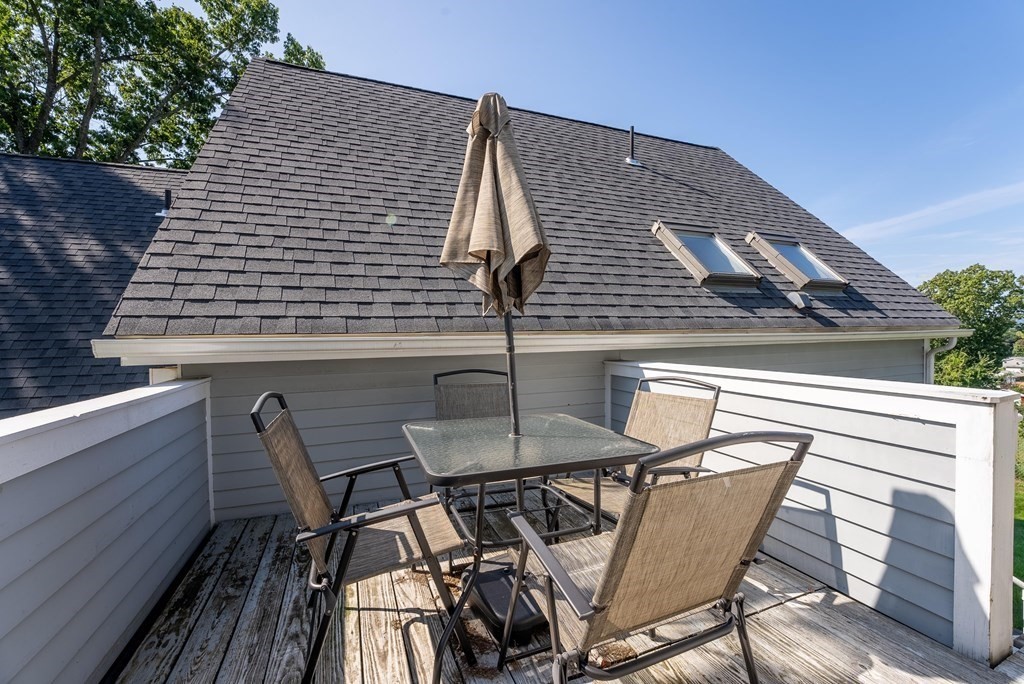 54 Kennedy Street Chicopee, MA 01013 - Photo 35 of 42 a roof deck with table and chairs