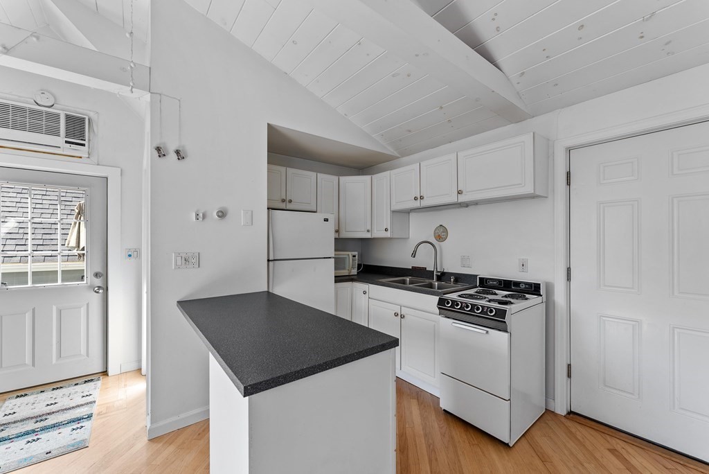 54 Kennedy Street Chicopee, MA 01013 - Photo 36 of 42 a kitchen with granite countertop a sink stove and refrigerator