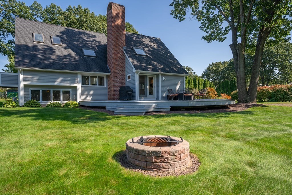54 Kennedy Street Chicopee, MA 01013 - Photo 6 of 42 a front view of a house with a garden and trees