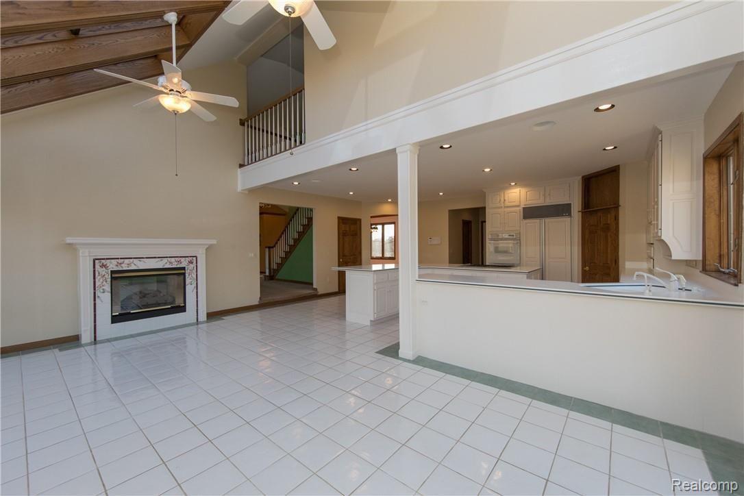 7432 Dutch Road Goodrich, MI 48438 - Photo 20 of 35 A Warm Double-Sided Fireplace and Area is Open to Great Room and you can see the Loft on upper level