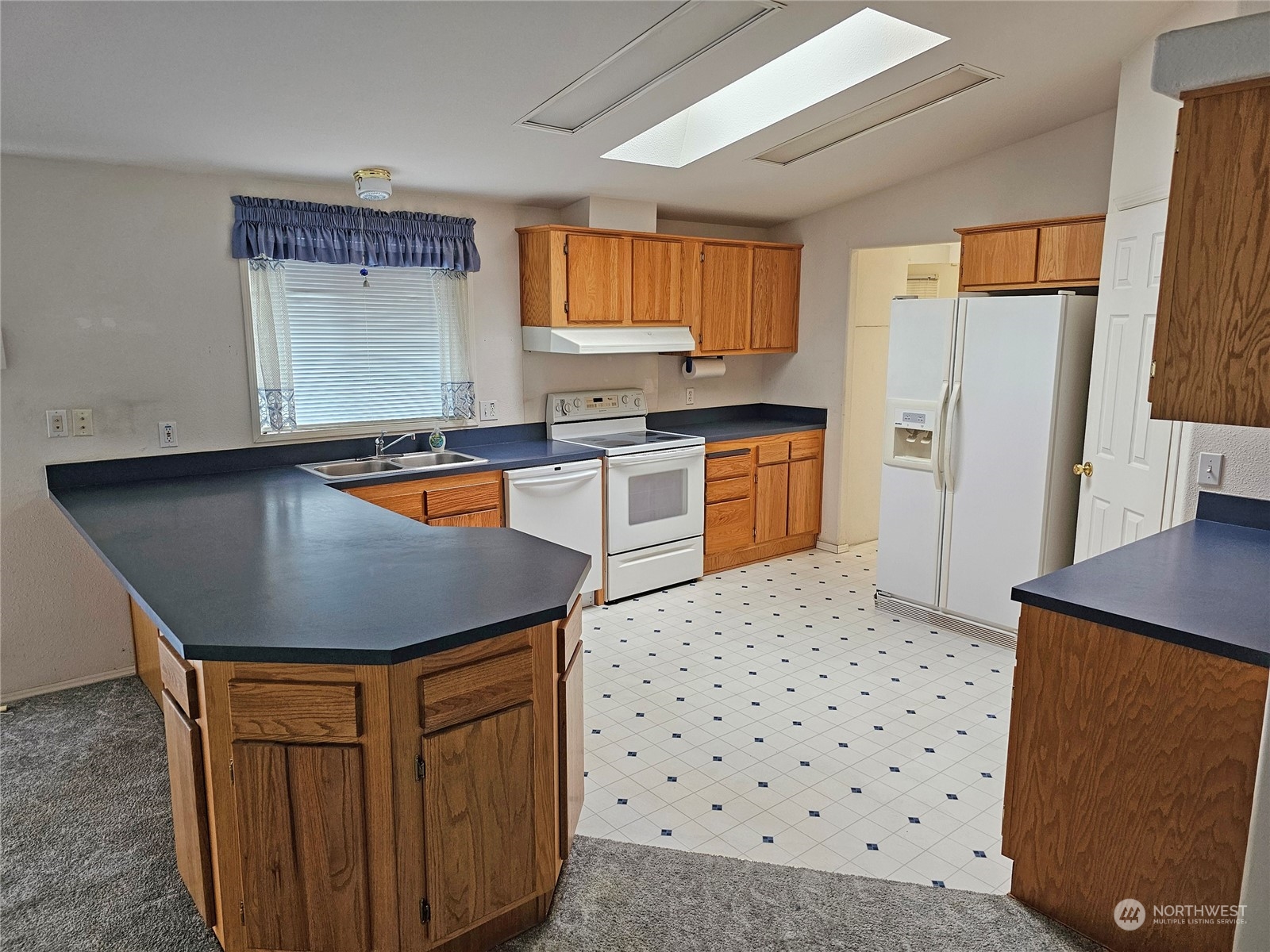 9139 178th Avenue Southwest Rochester, WA 98579 - Photo 9 of 29 a kitchen with stainless steel appliances a refrigerator a sink a stove a counter space and a window