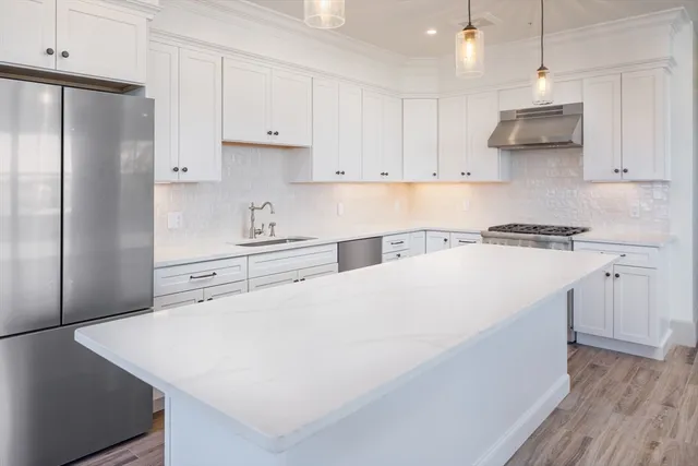 a kitchen with cabinets and stainless steel appliances