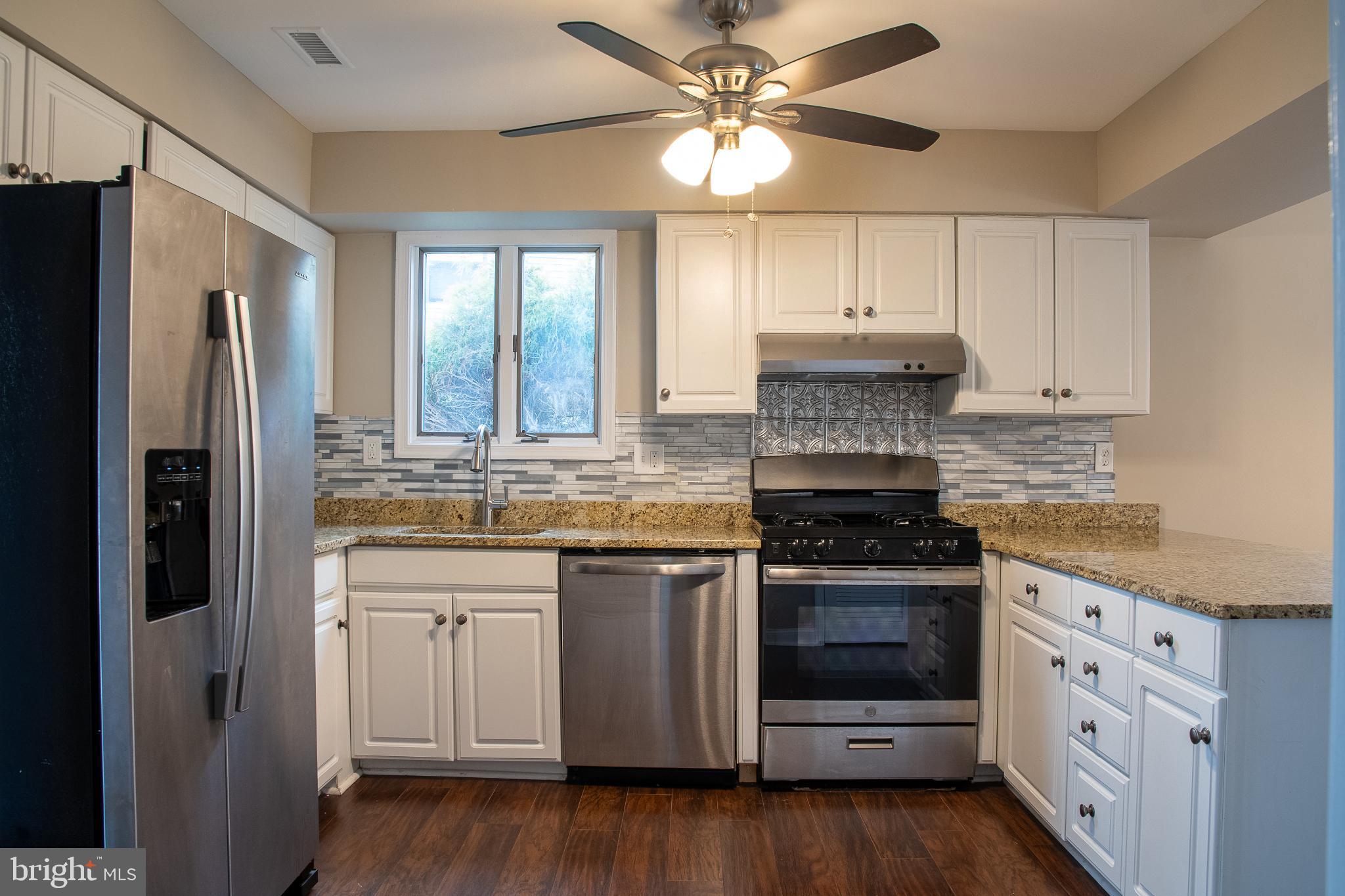 22 Duncan Road Sewell, NJ 08080 - Photo 22 of 46 a kitchen with stainless steel appliances granite countertop a stove a refrigerator and a stove top oven