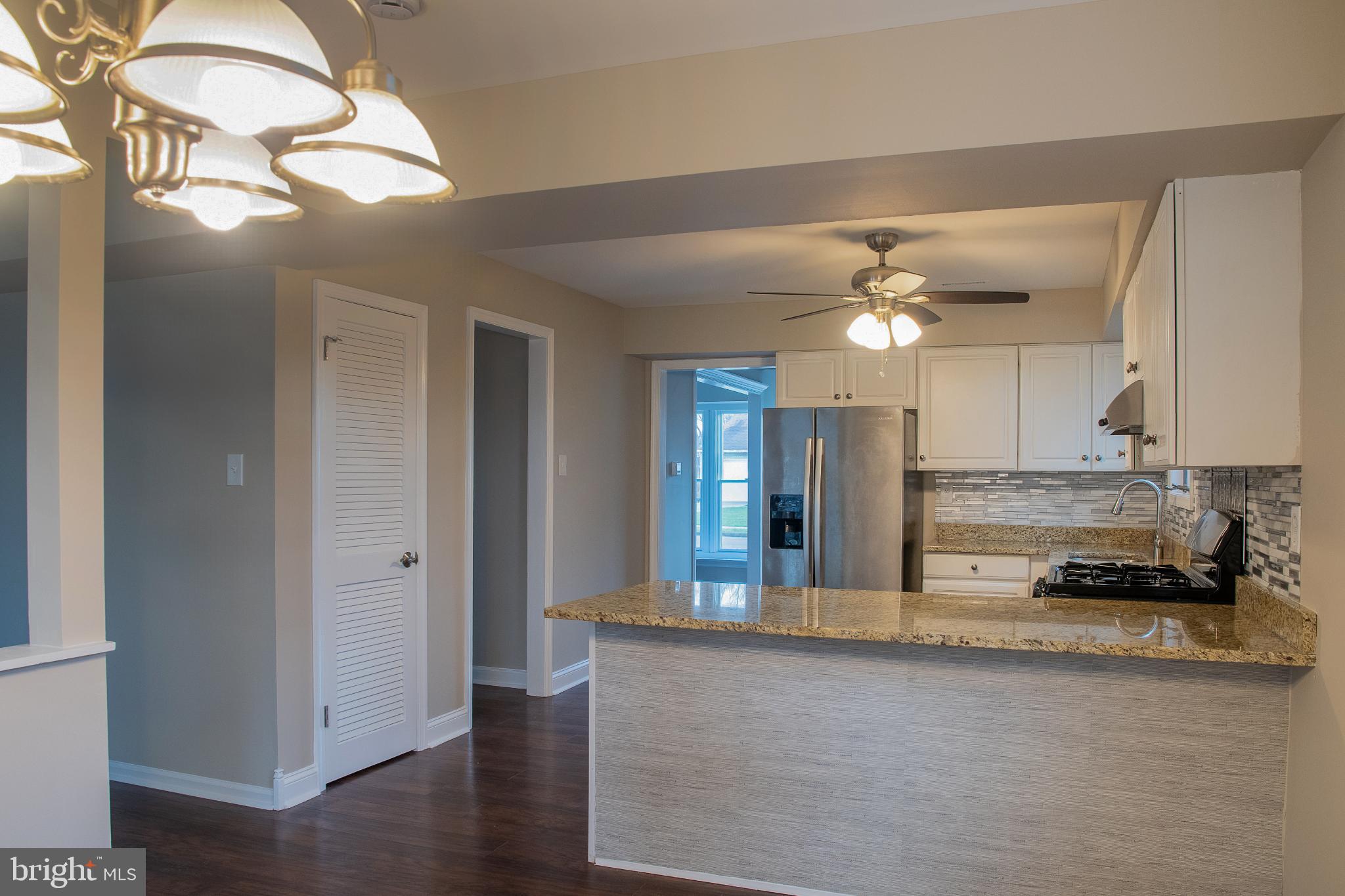 22 Duncan Road Sewell, NJ 08080 - Photo 24 of 46 a view of a kitchen island a chandelier and wooden floor