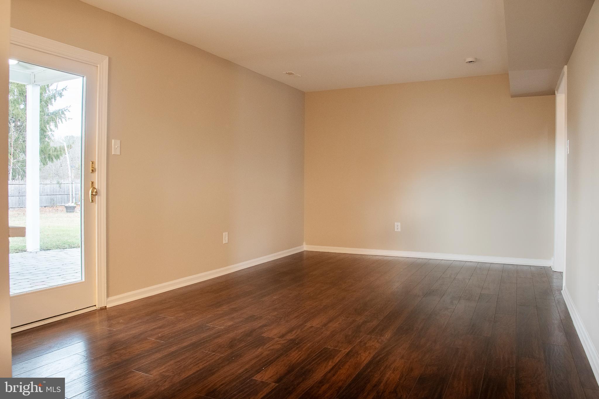 22 Duncan Road Sewell, NJ 08080 - Photo 32 of 46 a view of an empty room with wooden floor and a window