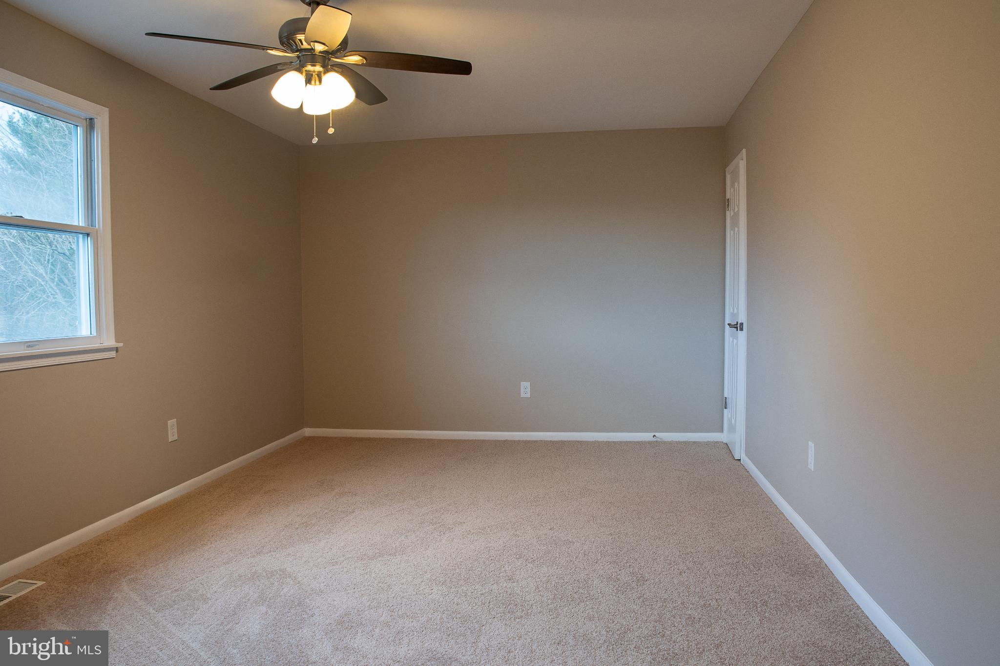 22 Duncan Road Sewell, NJ 08080 - Photo 34 of 46 an empty room with a chandelier fan and windows